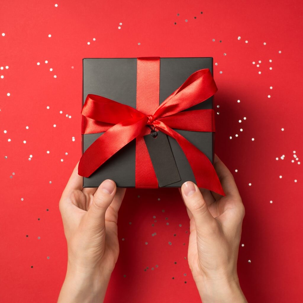 Gift Box with Ribbon Tied in a Bow and Gift Tag