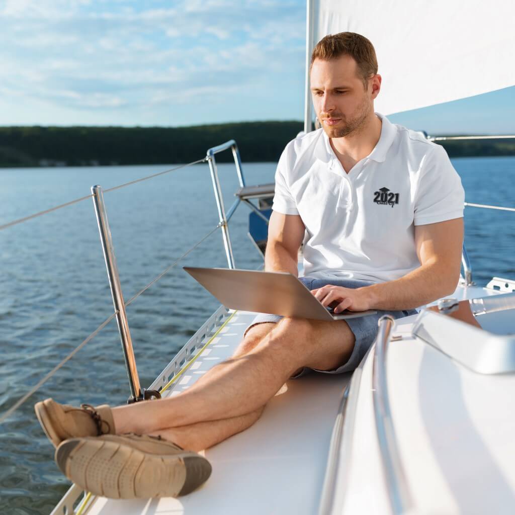 Man Wearing White Polo Shirt On Boat