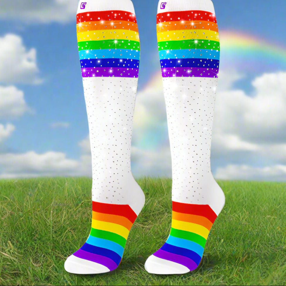 rainbow sparkly socks in field with rainbow